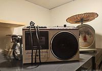 Front view of GE radio cassette beside dial scale