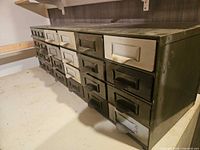 Angled view showing side and drawer fronts of metal cabinet