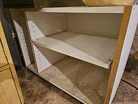 Overall view of cabinet showing open front and shelf mounts