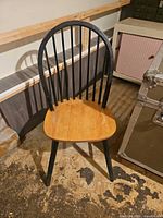 Full front view of chair showing two-tone wood finish
