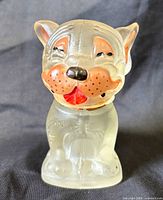 Front view of frosted glass Bonzo Dog perfume bottle showing painted face and overall form