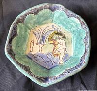 Top view showing bowl shape, scalloped rim and interior sgraffito decoration