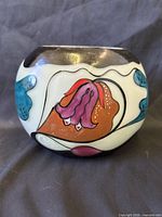 front view of signed enameled glass vase