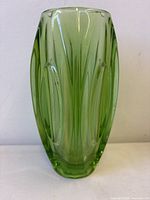 Front view green art glass vase showing pattern and color