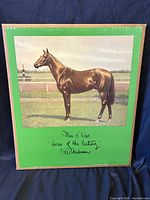 Front of portfolio showing color lithograph of Man O' War and printed signature