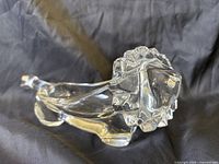 Perspective view of crystal lion showing facial detail and pipe rest body
