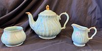 Tea set front view showing teapot, creamer, sugar bowl