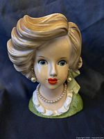 Front view of Relpo lady head vase showing facial features, hair style, earrings and necklace
