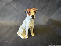 Front view of porcelain seated foxhound figurine