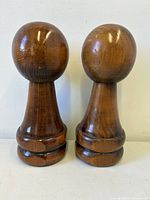 Front view of both wooden pawn-shaped bookends standing upright