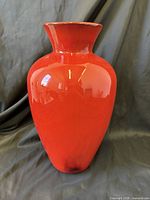 Front view of magenta red ceramic vase showing overall shape and glossy finish