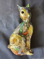 Front angled view of multicolored glass cat figurine