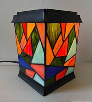 Lamp illuminated showing multicoloured stained glass panels