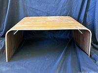 Front view of bentwood stand showing curved top and sides