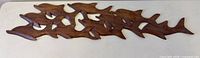 Front view of entire carved dolphin plaque