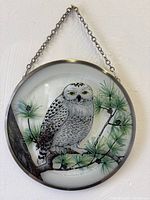 Front view of round stained glass snowy owl hanger with chain