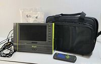 Front view of Hype portable DVD player with cords, remote, carry case, manual