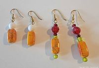 Both pairs of earrings front view showing bead arrangement and hooks