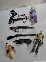Overview of entire lot: two action figures, Grogu figure and six weapons laid out