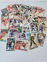 Spread view of assorted NHL hockey cards showing variety of players and sets