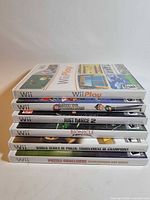 Stacked view of six Wii game cases showing all titles
