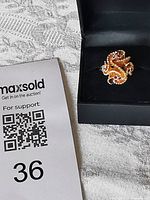 Ring in box beside lot card, shows scale and presentation