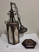 Full view of lantern with chain, canopy and mounting block