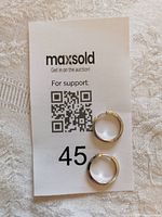 pair of silver hoop earrings on label