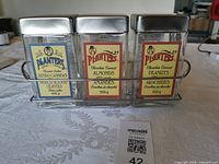 Front view of three labeled Planters jars in rack