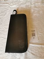 closed black zippered case on table