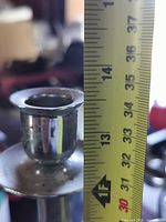 measuring tape showing candlestick height about 14 in