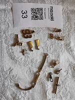 Overall lot showing watch band, charms, clasps