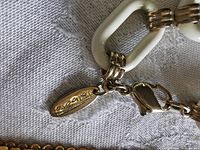 Close-up of Talbots tag, white resin link, and lobster clasp