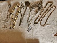 All six necklaces laid out showing overall styles and materials