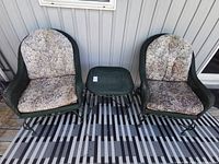 Two chairs and table on patio with cushions