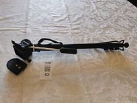Full view of telescopic monopod with quick-release plate and wrist strap displayed on table