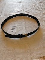 Entire belt arranged in oval showing buckle and strap