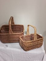 Front view of both wicker baskets showing size difference and handles