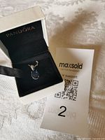 Necklace in Pandora box with auction tag visible