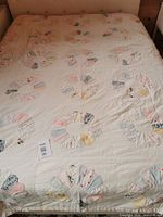 Full view of quilt laid on queen bed showing pattern blocks