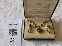 Necklace and earrings in original Queen Isabella box with lot card visible