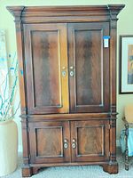 Front view of mahogany entertainment cabinet with double doors upper and lower
