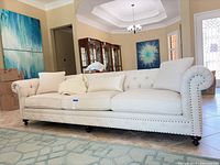 Full view of Bernhardt ivory Chesterfield sofa in room setting