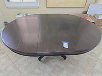 Top view of table showing oval shape with leaf inserted
