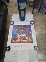 Lithograph laid flat with certificate and blue storage tube