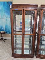 full frontal view of cabinet showing doors, glass panels, hardware