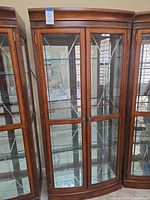 Front view of entire cabinet showing glass doors and wood frame