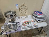 Overall lot showing chafing dish, rack, stack of platters and Mariposa tray