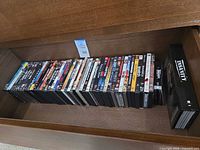 Full drawer view showing entire row of DVD cases and Insanity box set
