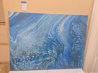 Front view of entire blue and white acrylic pour painting with metallic accents